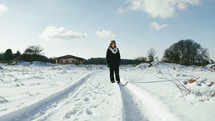 woman walks in fresh snow