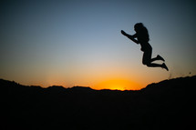 silhouette of a woman jumping 