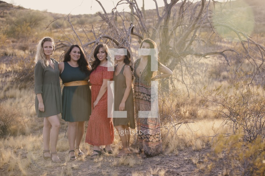 women's standing together in a desert 