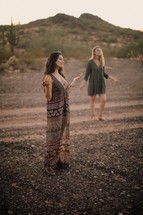 women praying in a desert 