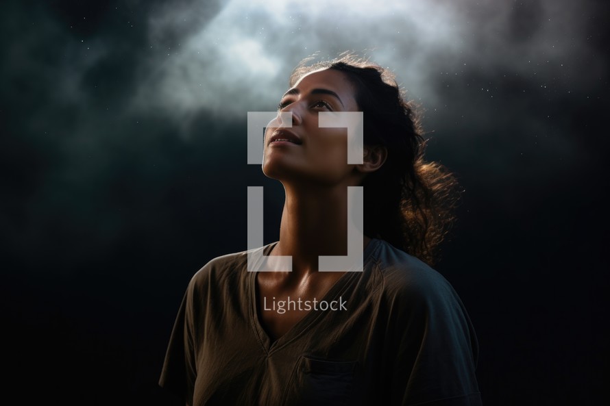 Portrait of a beautiful young woman on a dark background with smoke