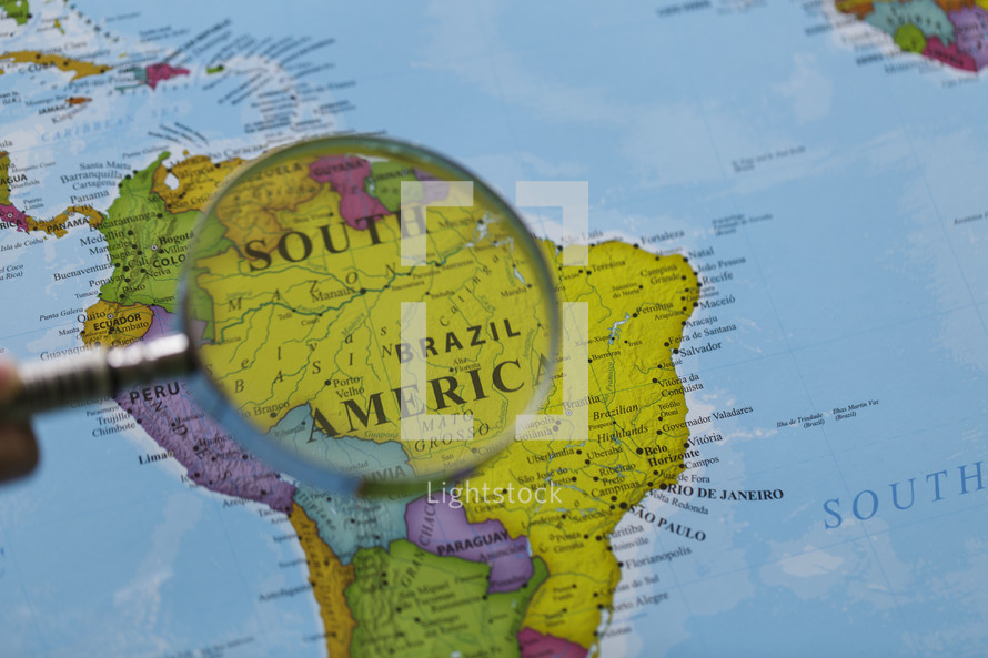 magnifying glass over a map of South America 