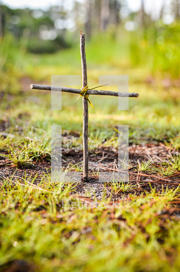 cross made from sticks in the ground