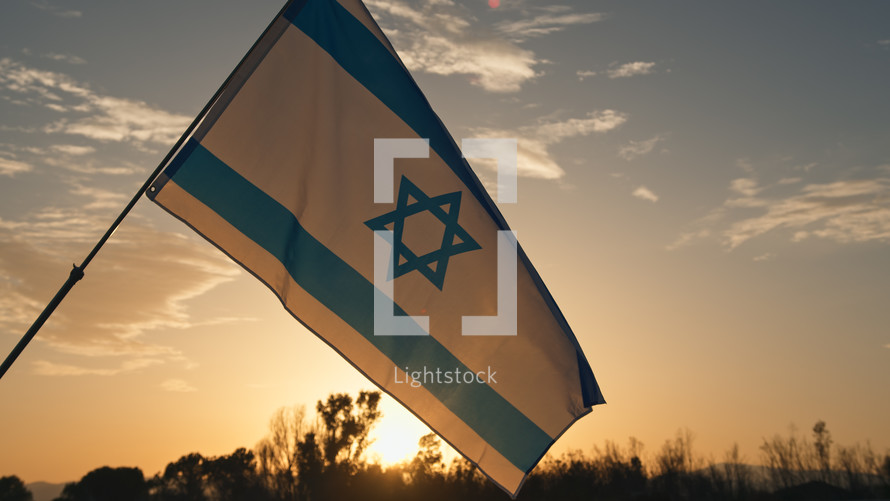 Israel flag Waving In the Sky at sunrise