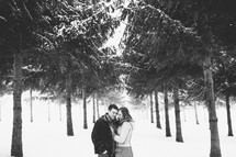 a couple hugging in the snow 