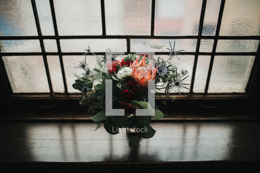 flowers in a vase in a window sill 