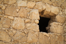 Window in stone wall Masada, Israel