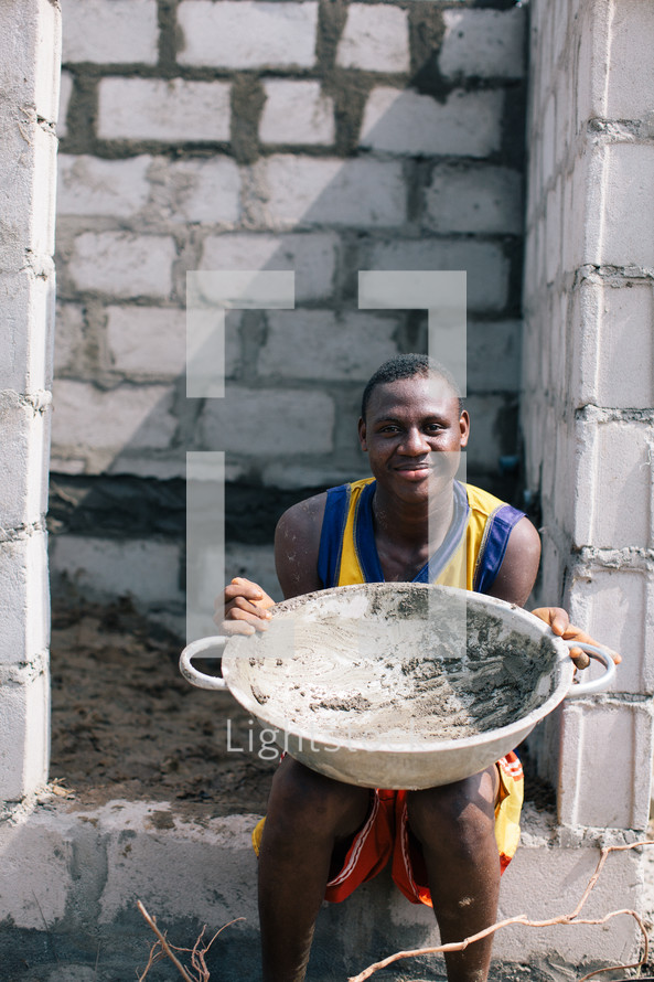 man holding a large bowl in Nigeria 