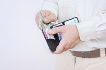 man pulling out cash from his wallet 
