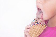 child licking an ice cream cone 