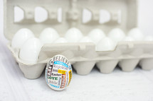 Easter egg and eggs in a carton