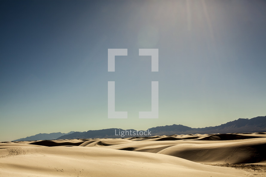 sunlight over sand dunes 