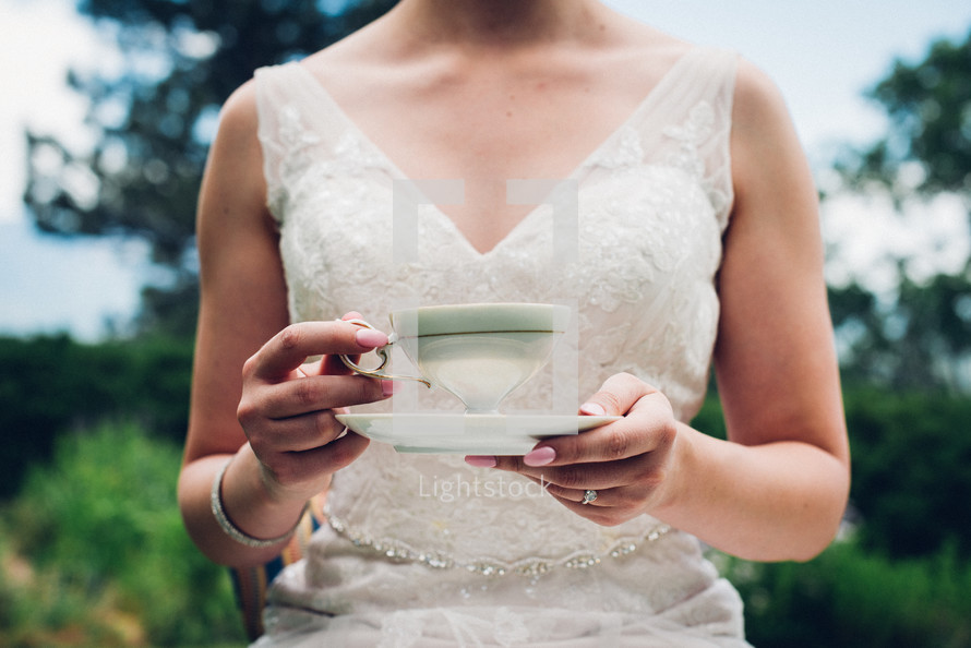 a bride holding a tea cup 