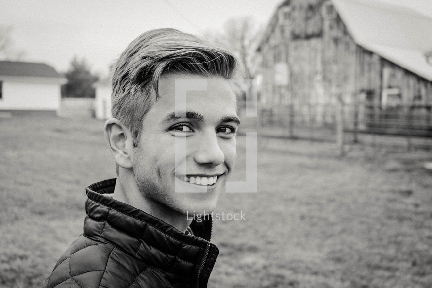 a smiling young man on a farm 