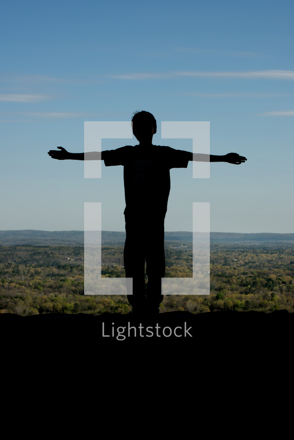 child silhouette in the shape of a cross