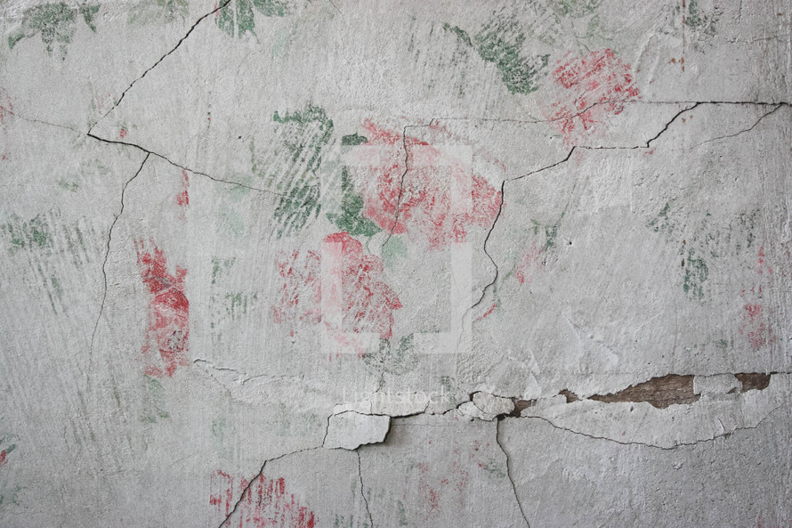 floral pattern on a pealing plaster wall 