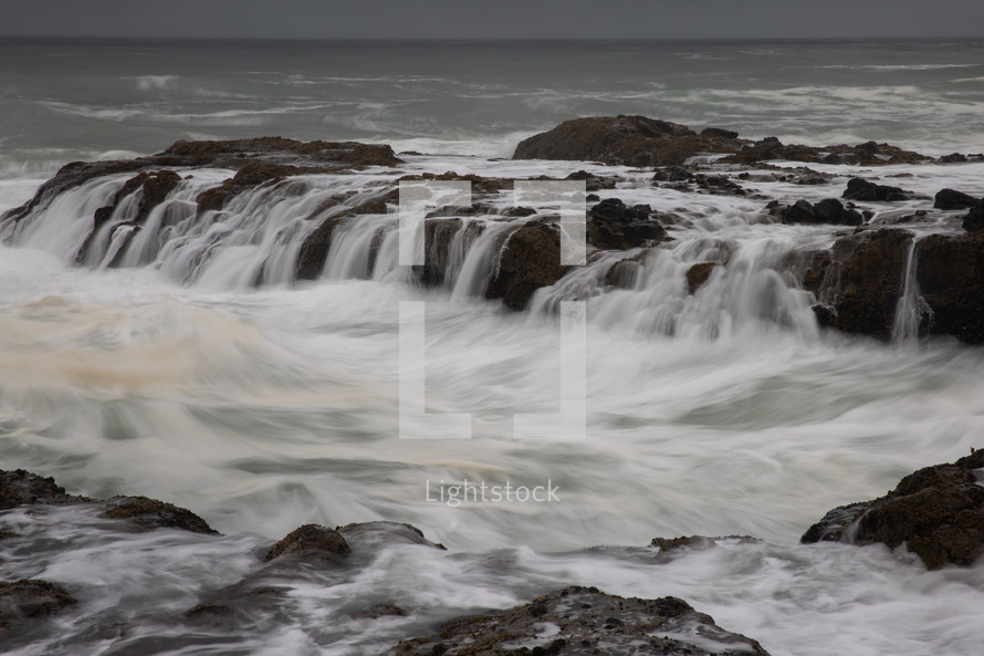 water flowing over rocks at a shore in Oregon 