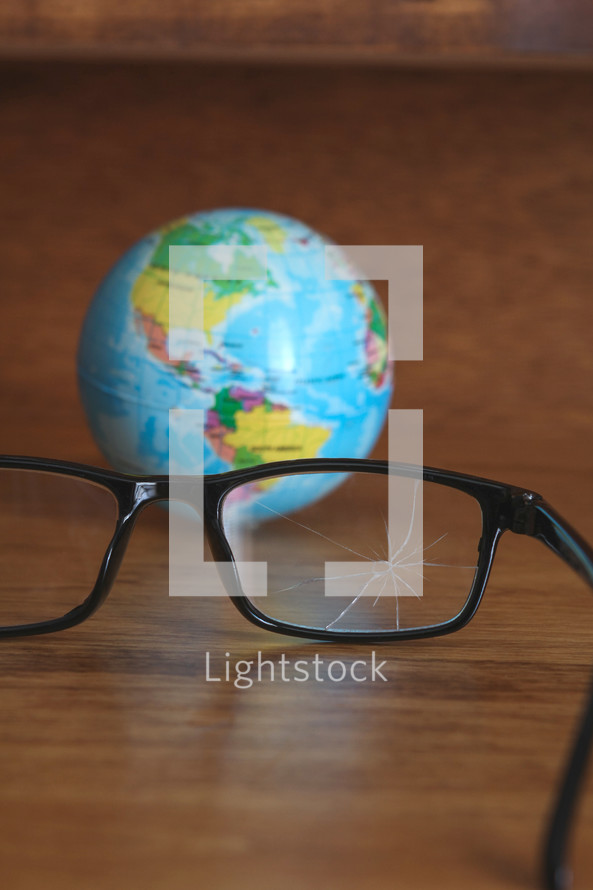 shattered glasses and globe 