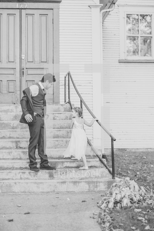 father and daughter walking up church steps 