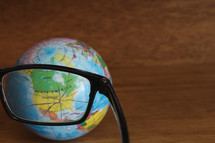 broken glasses and a globe 