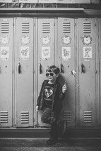 a boy standing in front of lockers 