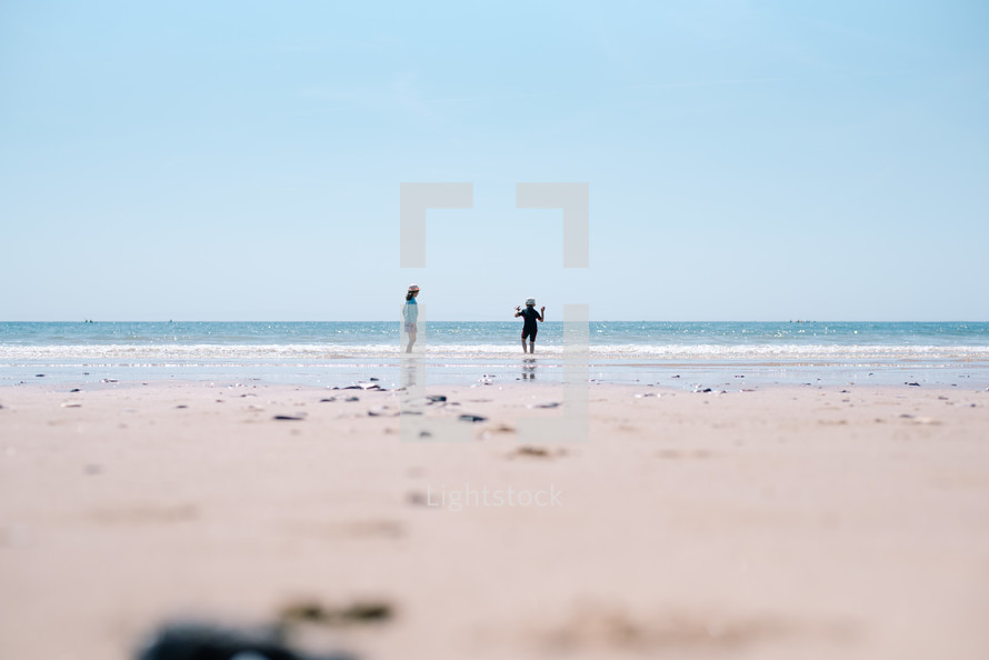 distant children playing on a beach 
