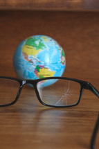 shattered glasses and globe 