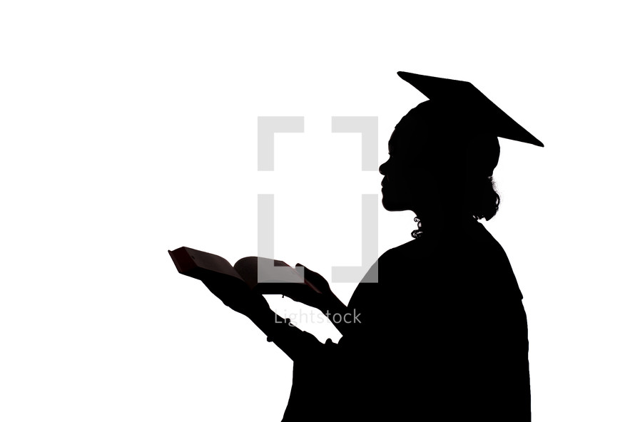 silhouette of a graduate holding a Bible 