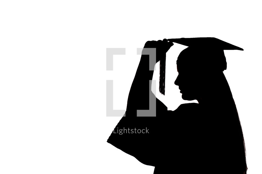 silhouette of a graduate turning her tassel 