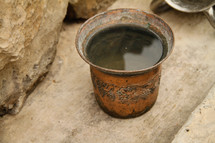 Handmade copper cup full of water