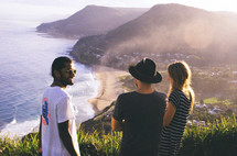 friends looking out at a view of the shoreline Lighthouse Beach headland in Port Macquarie, Australia 