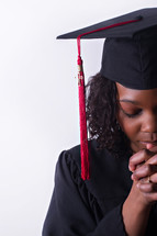 face of an African American graduate in prayer 