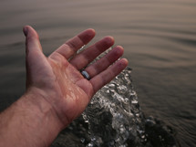 hand touching water 