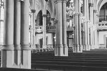 rows of pews inside a cathedral 