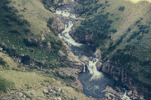 aerial view of a river and waterfall 