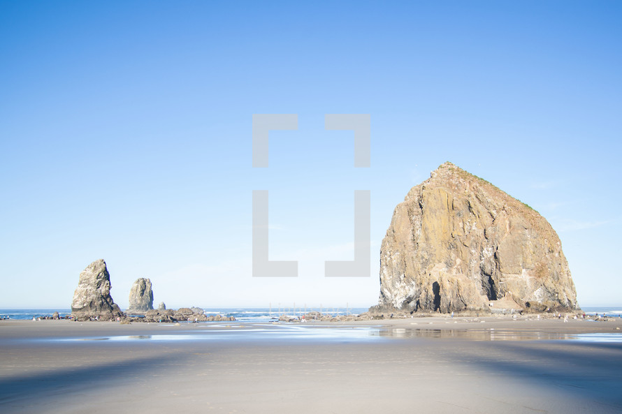 large rock formations on a beach 