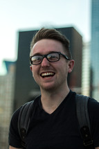 A smiling young man in glasses.