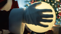 Santa claus touching a magical sphere
