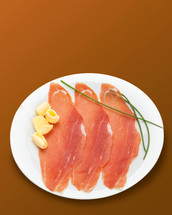 Raw ham on white plate