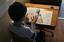 child doing school work at home 