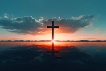 Cross reflected on the sea with sunset background
