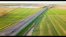 Vehicles cars travel in the highway near the green nature aerial view