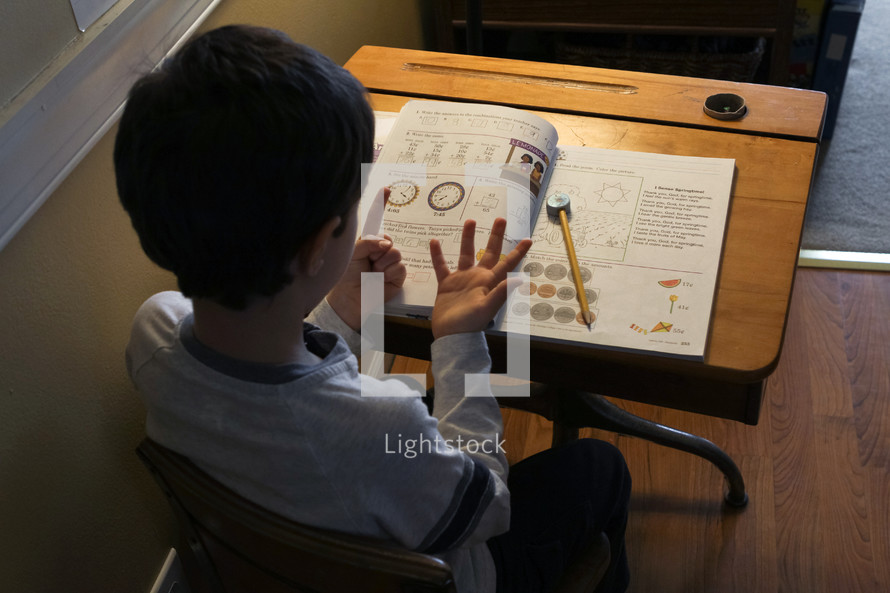 child doing school work at home 