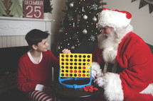 Santa and a boy playing connect four 