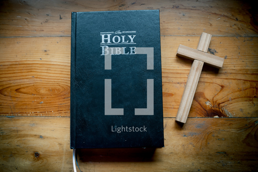 Bible with Cross is placed on a wooden table on Sunday. worship prayer and bible study concept.