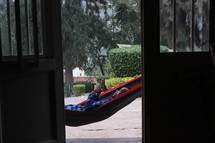 a man resting in a hammock 