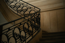 Stone staircase with an iron handrail banister, decorative metal work, marble floor, beautiful design