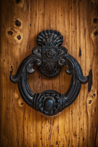 Antique handle of a solid wood door in Tuscan style