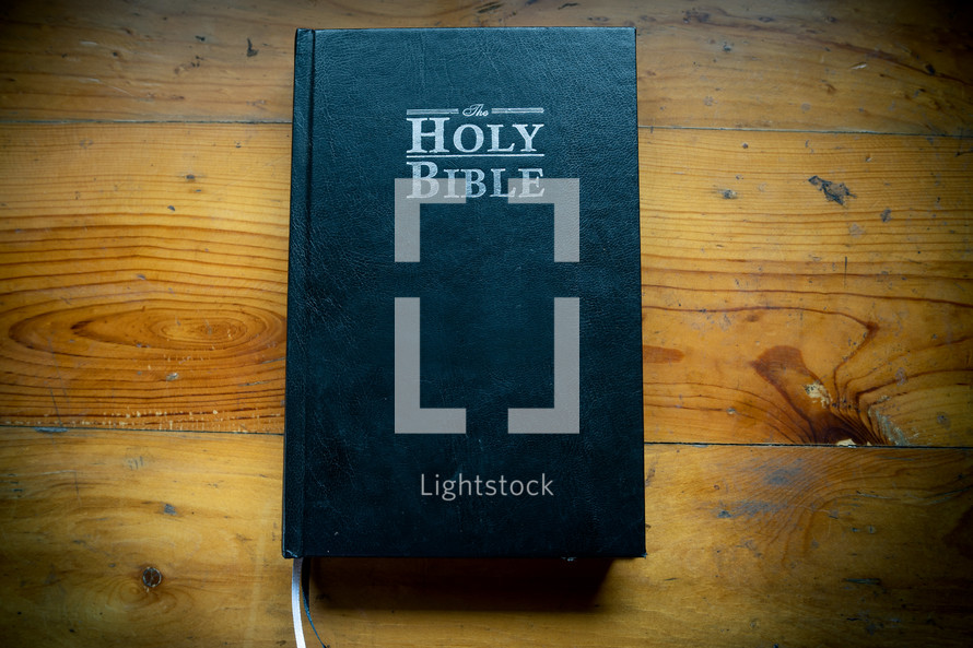 Holy Bible placed on a wooden table in morning. worship prayer and bible study concept.