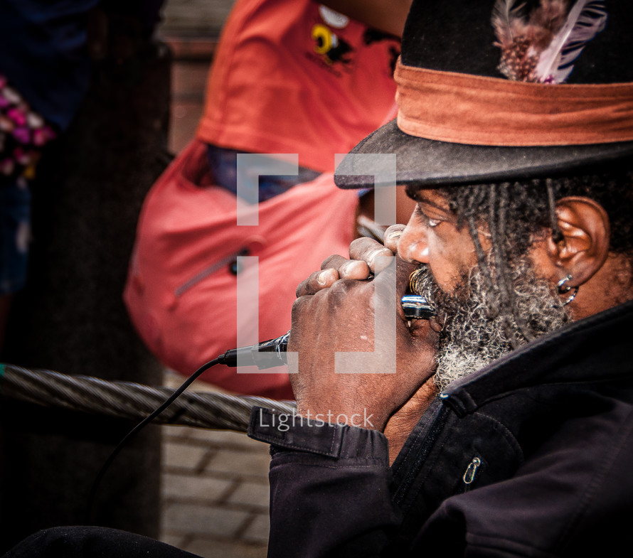 man playing a harmonica 